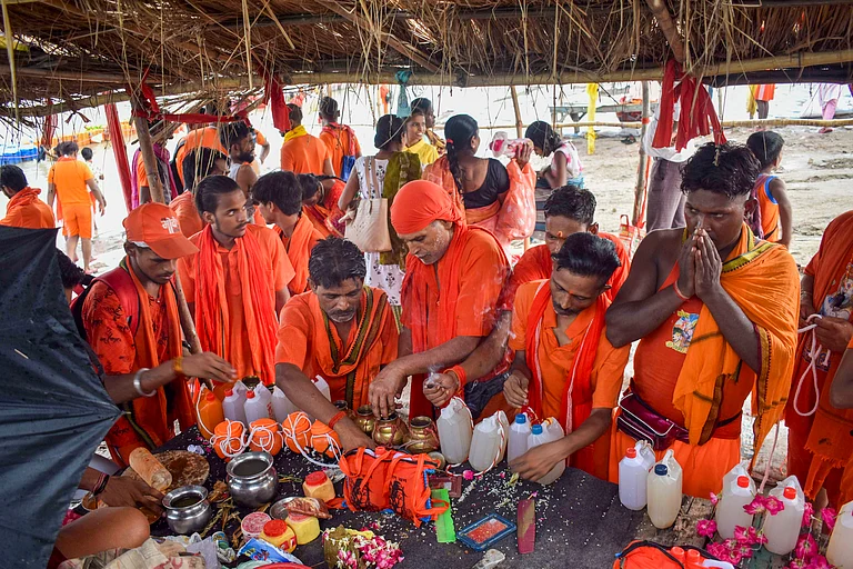 'Kanwariyas' upon their return after collecting sacred water from Ganga river for Lord Shiva's worship during the holy month of 'Shravan', in Prayagraj, - PTI